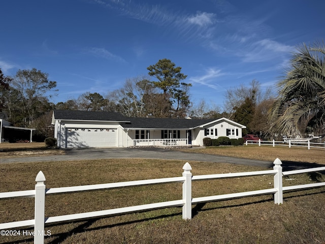 view of front of house with a porch, a garage, and a front lawn