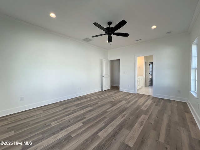 unfurnished bedroom featuring crown molding, dark wood-type flooring, ceiling fan, and ensuite bath