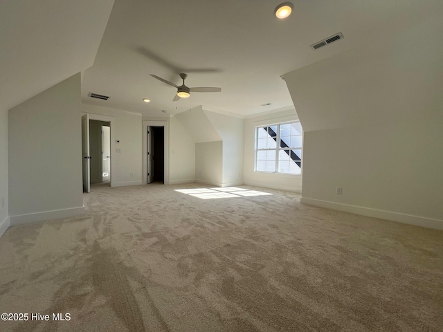 additional living space featuring light colored carpet and ceiling fan