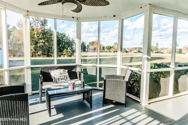 sunroom featuring ceiling fan