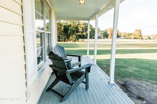 wooden terrace with a yard