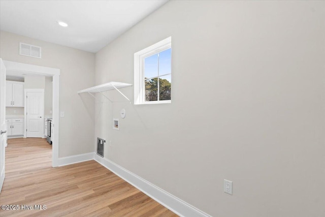 laundry room with gas dryer hookup, washer hookup, and light hardwood / wood-style flooring