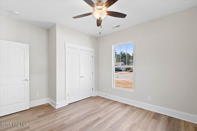 bathroom with walk in shower, vanity, toilet, and hardwood / wood-style floors