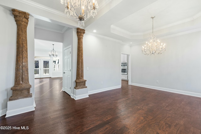 unfurnished dining area with decorative columns, dark wood finished floors, ornamental molding, french doors, and a chandelier