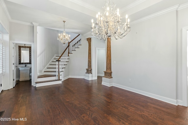 unfurnished dining area with ornate columns, dark wood-type flooring, a chandelier, baseboards, and stairs