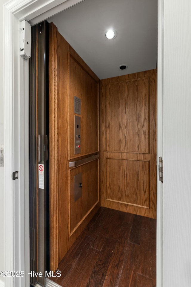 hall featuring elevator and dark wood finished floors