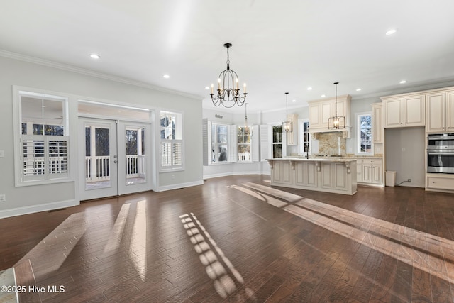 unfurnished living room with dark wood-style floors, french doors, ornamental molding, and baseboards