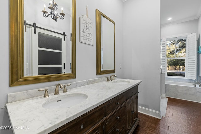 full bathroom featuring double vanity, a sink, a bath, and baseboards