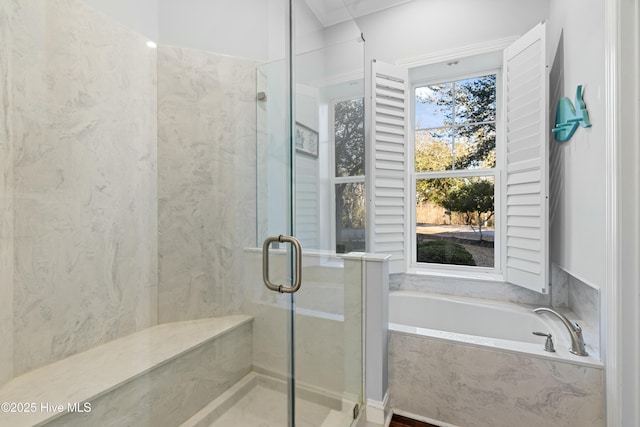 bathroom with a stall shower and a bath