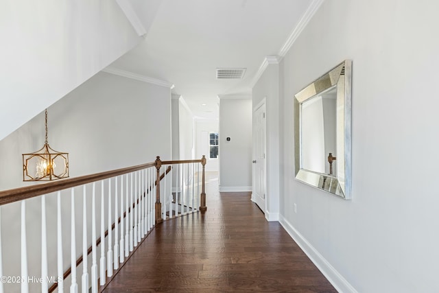 hall featuring baseboards, visible vents, wood finished floors, an inviting chandelier, and an upstairs landing