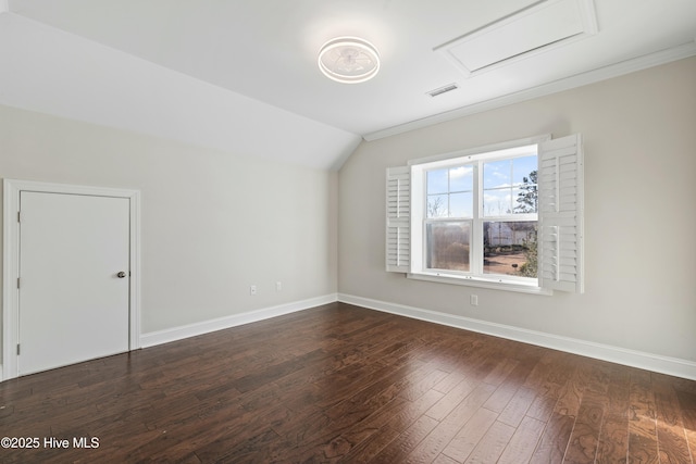 bonus room featuring vaulted ceiling, dark wood finished floors, visible vents, and baseboards