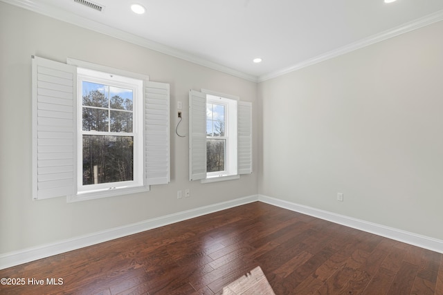 unfurnished room with crown molding, visible vents, dark wood finished floors, and baseboards