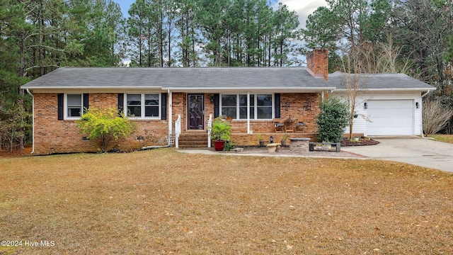 single story home with a front yard and a garage