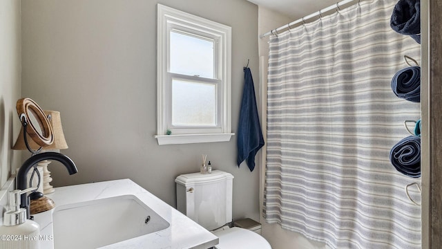 bathroom with toilet, a shower with shower curtain, and vanity