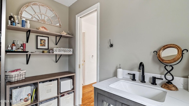 bathroom with wood finished floors and vanity