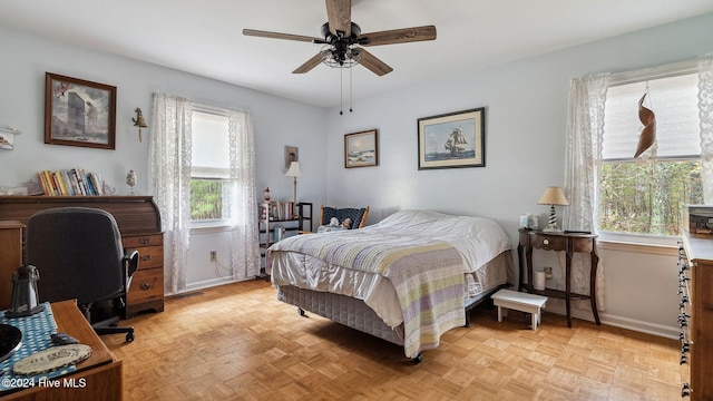 bedroom with ceiling fan and baseboards