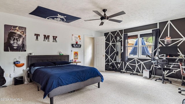 bedroom with carpet flooring, ceiling fan, and a textured ceiling