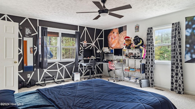 bedroom featuring carpet floors, a textured ceiling, baseboards, and a ceiling fan