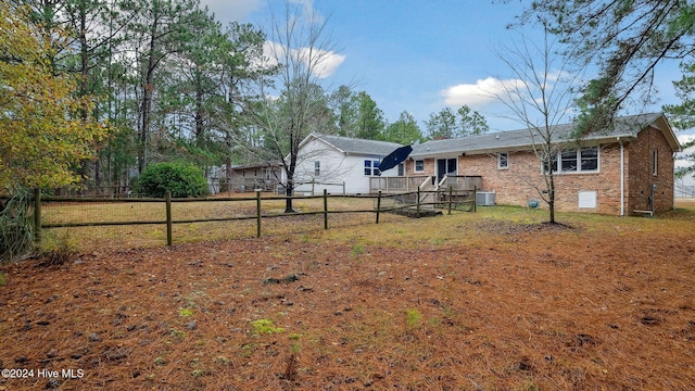 view of yard with fence and central AC unit