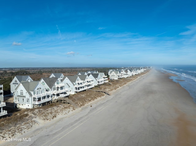 aerial view with a water view and a beach view