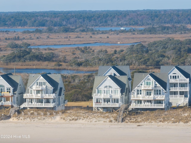 bird's eye view featuring a water view and a wooded view