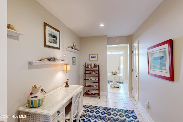 hallway with recessed lighting, baseboards, and light tile patterned flooring