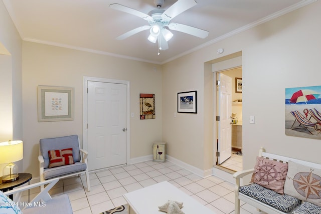 sitting room featuring ornamental molding, a ceiling fan, baseboards, and light tile patterned floors