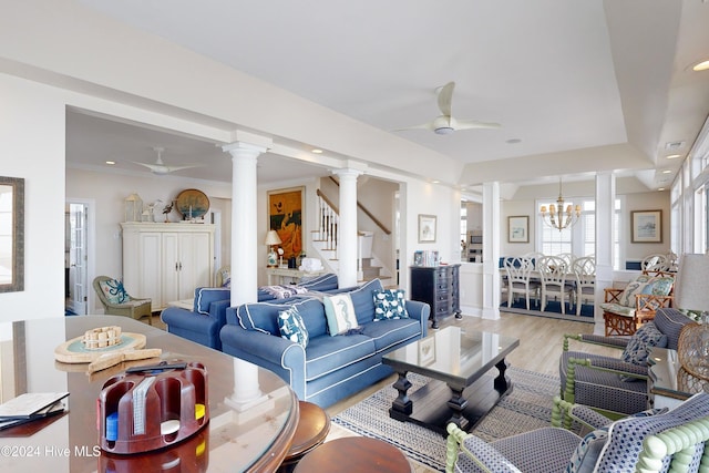 living area featuring recessed lighting, ceiling fan with notable chandelier, stairway, light wood-type flooring, and decorative columns