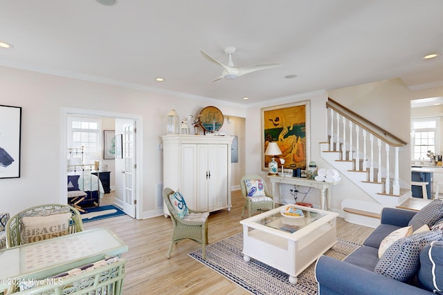 living room featuring light wood-style flooring, stairway, crown molding, and recessed lighting