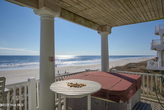 balcony with a water view and a beach view