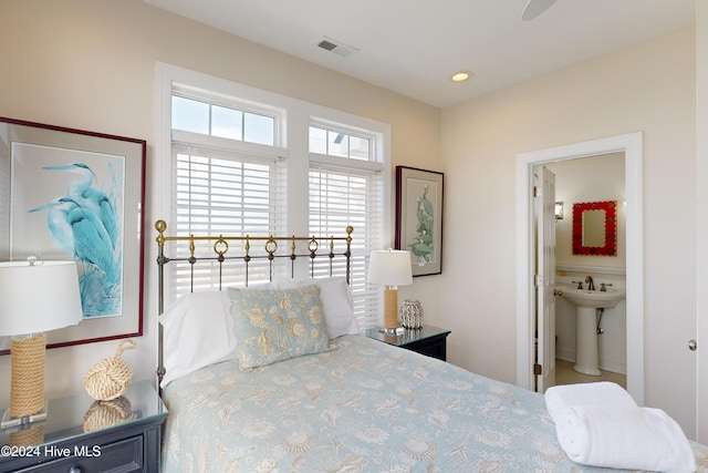 bedroom featuring ensuite bathroom, a sink, visible vents, and recessed lighting