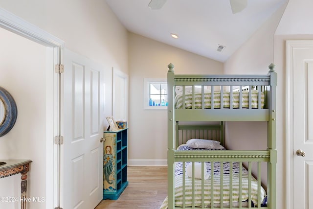 bedroom with baseboards, visible vents, wood finished floors, vaulted ceiling, and recessed lighting