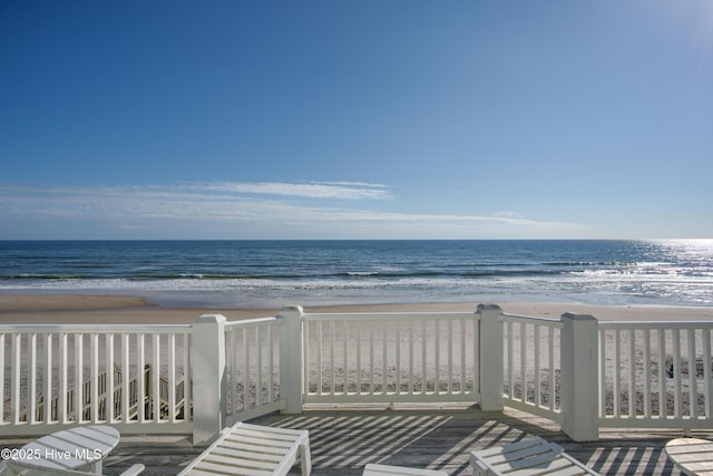 view of community featuring a beach view and a water view