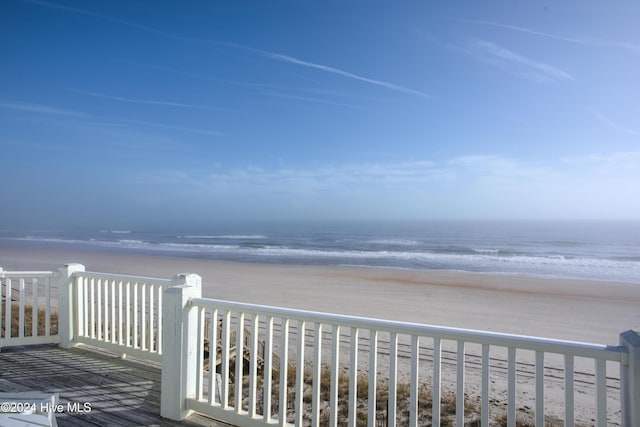 wooden terrace with a water view and a beach view