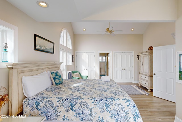 bedroom featuring ceiling fan, wood finished floors, vaulted ceiling, two closets, and recessed lighting