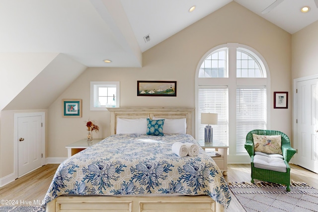 bedroom with light wood finished floors, lofted ceiling, recessed lighting, visible vents, and baseboards