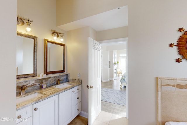 full bath featuring double vanity and a sink