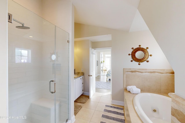 full bath featuring vaulted ceiling, a shower stall, vanity, a tub with jets, and tile patterned floors