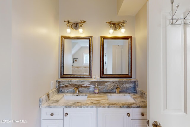 bathroom featuring a sink and double vanity