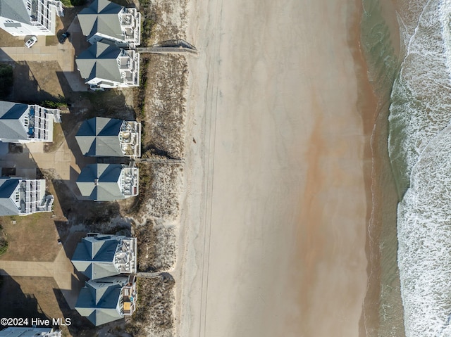 drone / aerial view featuring a water view and a view of the beach