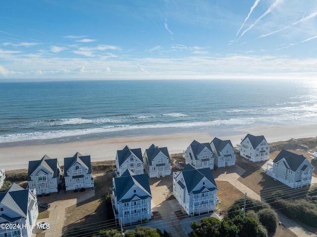 birds eye view of property featuring a beach view, a residential view, and a water view