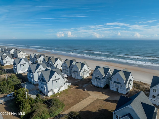 birds eye view of property featuring a water view, a residential view, and a view of the beach