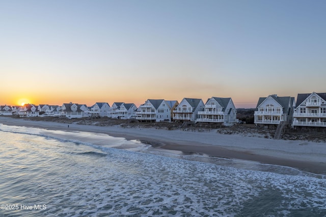 exterior space with a residential view and a view of the beach