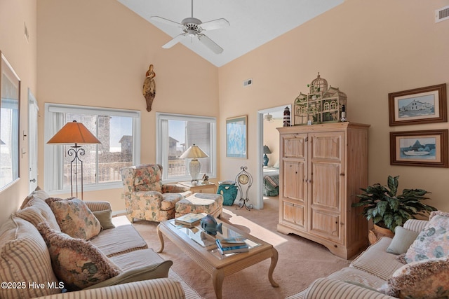 carpeted living room featuring ceiling fan and high vaulted ceiling