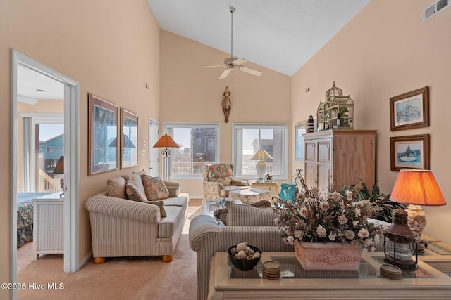 carpeted living room featuring ceiling fan and high vaulted ceiling