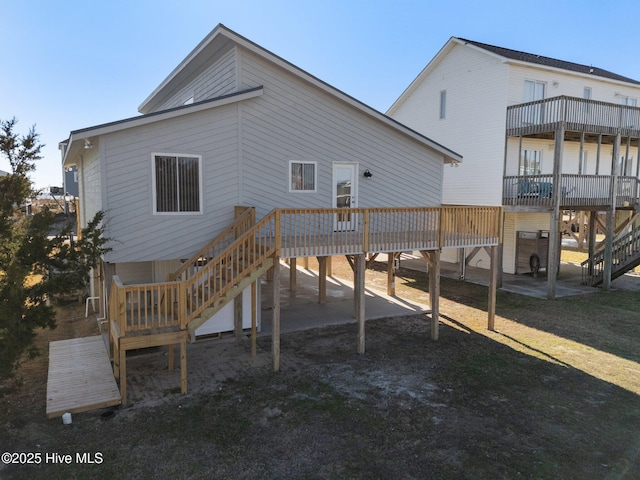 rear view of house featuring a wooden deck