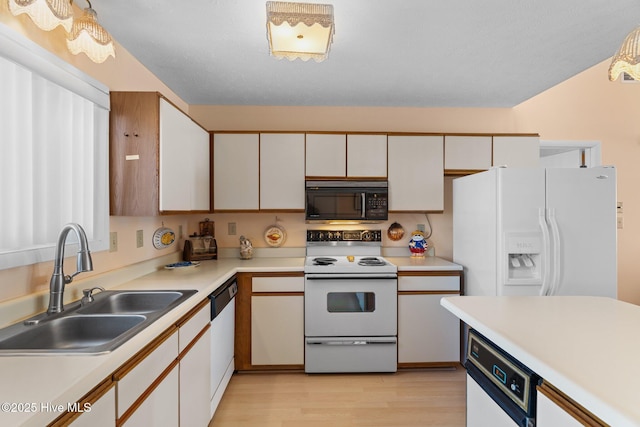 kitchen featuring light hardwood / wood-style floors, white cabinetry, white appliances, and sink