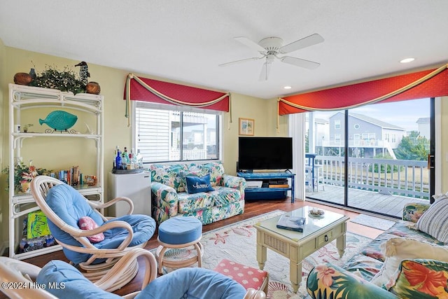 living room featuring hardwood / wood-style flooring and ceiling fan