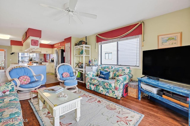 living room featuring ceiling fan and hardwood / wood-style flooring