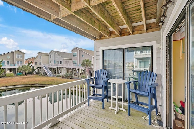 wooden terrace featuring a water view